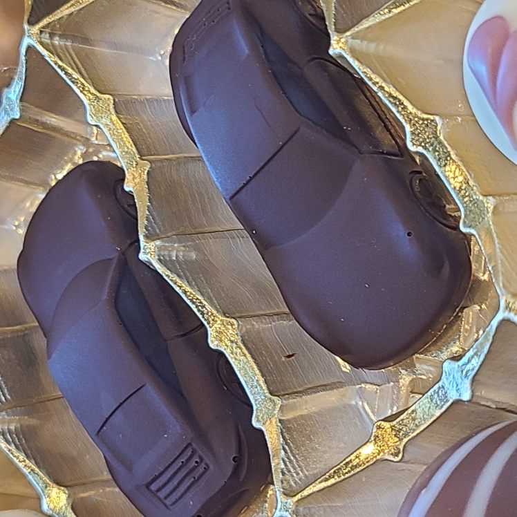 Detailed dark-chocolate sports cars in gold packaging